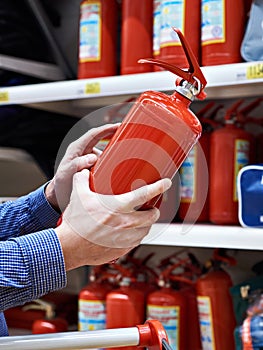 Buyer with fire extinguisher in hands at store