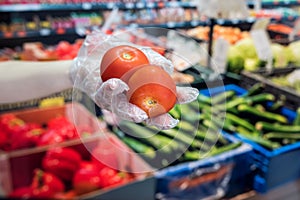 Buyer in gloves chooses vegetables during a pandemic due to a new dangerous virus, coronavirus