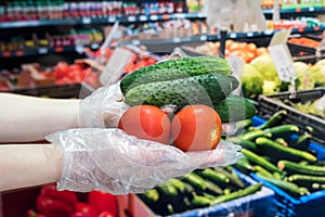Buyer in gloves chooses vegetables during a pandemic due to a new dangerous virus, coronavirus