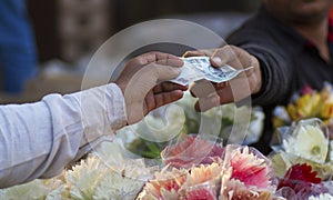 A buyer making payment to shopkeeper