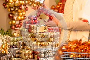 Buyer shopping Christmas balls in plastic boxes