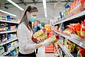 Buyer wearing a protective mask.Shopping during the pandemic quarantine.Nonperishable smart purchased household pantry groceries