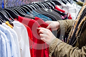 Buyer woman chooses clothes in store