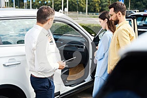 Buyers inspect the interior of the car