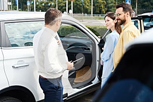 Buyers inspect the interior of a new car
