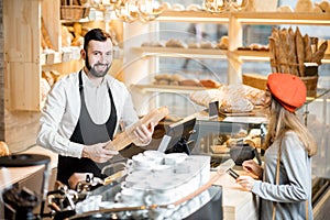 Buying a baguette in the bakery store