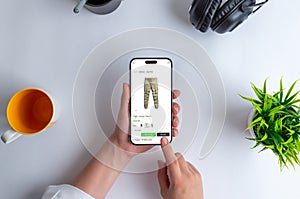 Buying cargo pants online through an ecommerce website. The phone is in your hands photo