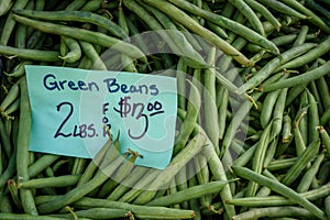 Buying fresh green beans in season at the local farmstand