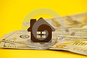 Buying house concept. Legal mortgage. Hose with money on the yellow table.