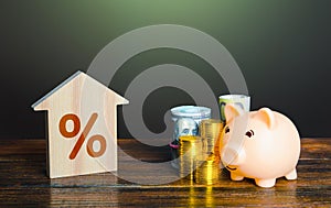 Buying a house with savings. Piggy bank and buying a home with a mortgage. Invest in real estate. Favorable conditions, low