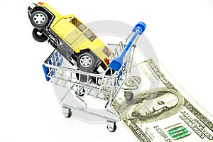 Buying new yellow car dollars on background