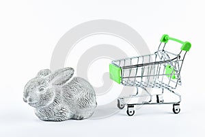 Buying rabbit trading concept. Shop online. Basket and rabbit on a white background. Healthy eating concept. Business concept