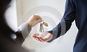 Buying real estate concept handing house keys