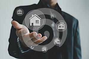 Buying, selling and renting houses or real estate concept, property online, Businessman hands on a virtual screen concept