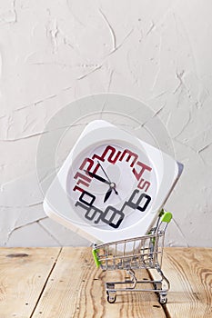 Buying time. Buy few more hours. A clock in shopping cart. purchase time