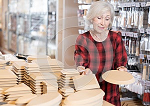 Buying wooden molds for clay products in pottery shop