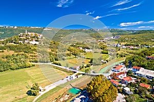 Buzet. Hill town of Buzet and Mirna river in green landscape aerial view