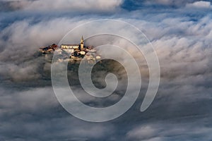 Buzet old town, Croatia over morning clouds.