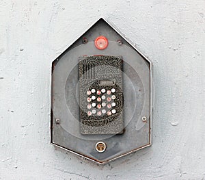Buzzer door intercom on a grey wall