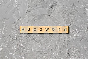 BUZZWORD word written on wood block. BUZZWORD text on cement table for your desing, concept