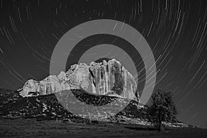 BW mountaine and startrails in sky photo