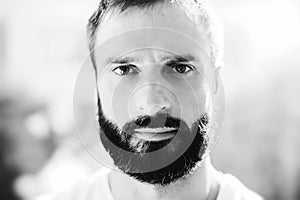 BW portrait of a bearded man wearing white tshirt