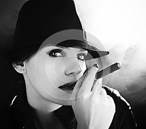 BW portrait of brunette smoking a cigar