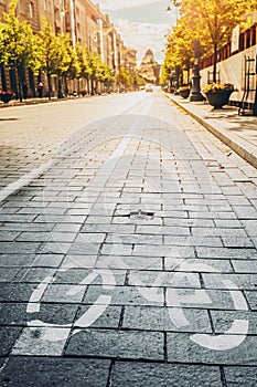 Bycycle Road Sign, Road Marking Of Bicycle Path Along Avenue Or Street In City In A Sunny Morning Or Evening At Sunset