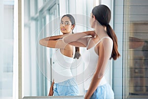 Bye-bye breakouts. an attractive young woman inspecting her back in front of the bathroom mirror.