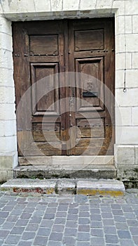 Bygone era old brown double entrance doors to dwelling house