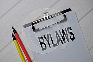 Bylaws write on a paperwork isolated on wooden table photo