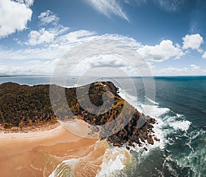 Byron Bay lighthouse high on the rocky headland - the most eastern point of Australian continent facing Pacific ocean in