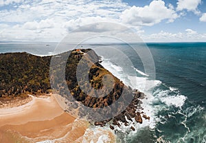Byron Bay lighthouse high on the rocky headland - the most eastern point of Australian continent facing Pacific ocean in