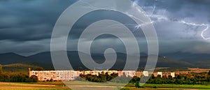 Bystrzyca Klodzka, electric discharge during a storm coming from the mountains, the valley illuminated by the setting sun