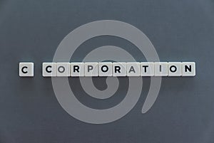 C corporation word made of square letter word on grey background