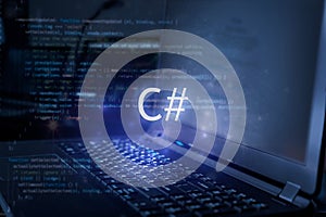 C# inscription against laptop and code background. Learn c sharp programming language, computer courses, training