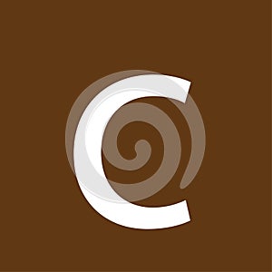 c letter on brown background