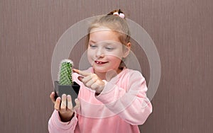 Little girl with a cactus