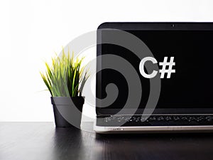 C Sharp programming language. Programming training, the concept of computer courses. Laptop on the table