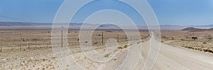 C13 gravel road and colorful flatland in Naukluft desert, north of Aus, Namibia