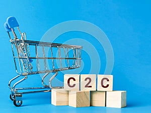 C2C stand for consumer to consumer on wooden cubes with trolley miniature.