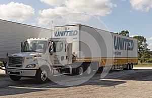 Cab and trailer parked up on truck stop area, Florida, USA