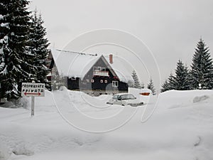 Cabana covered and car covered with snow