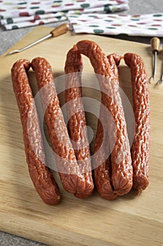 Cabanossi sausages close up for a snack on a cutting board