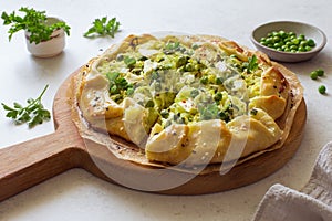 Cabbage, green peas and feta cheese open face piegalette close up