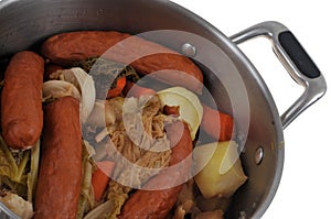 Cabbage hotpot in a Dutch oven close-up on a white background