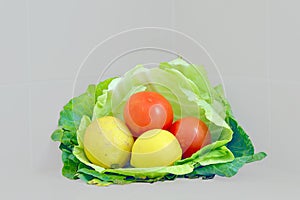 Cabbage leave basket with tomatoes and lemons