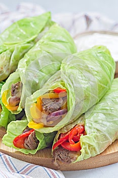 Cabbage leaves wraps with beef, vegetables and cheese, served with plain yogurt, vertical
