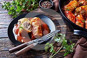 Cabbage rolls served on a black plate