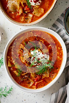 Cabbage rolls soup in a ceramic bowl on a table. .style hugge